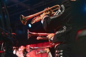 MEXICAN MUSICIAN MARIACHI WITH TRADITIONAL TRUMPET IN MEXICAN SERENATA